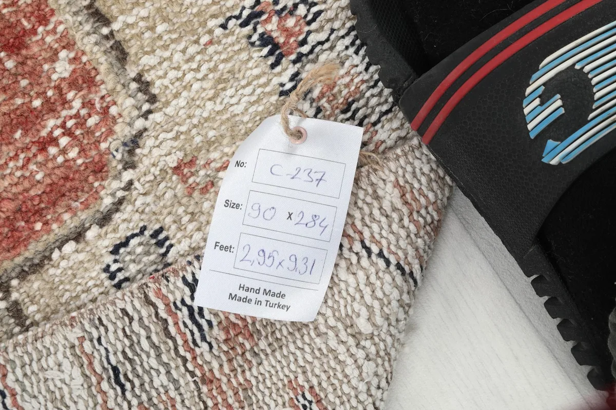 Close-up of the product tag indicating the rug's dimensions and 'Hand Made in Turkey'