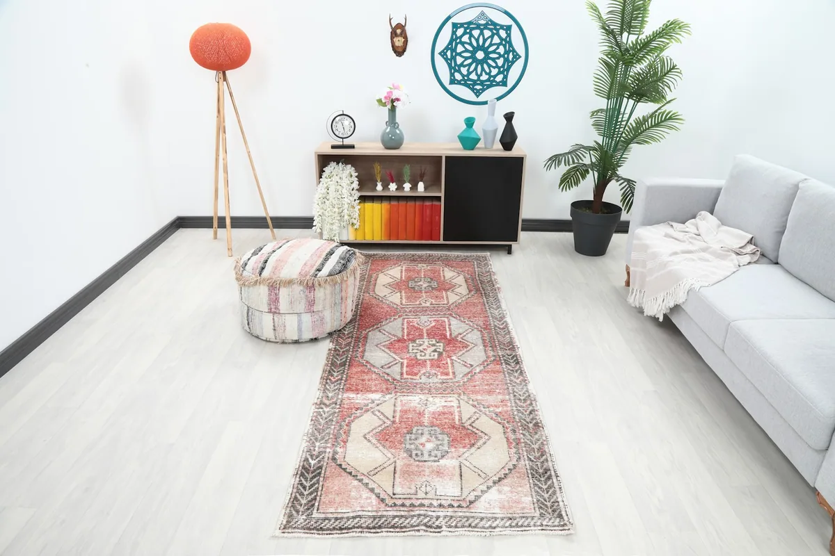 Vintage runner rug in a modern room setting with a sofa and ottoman