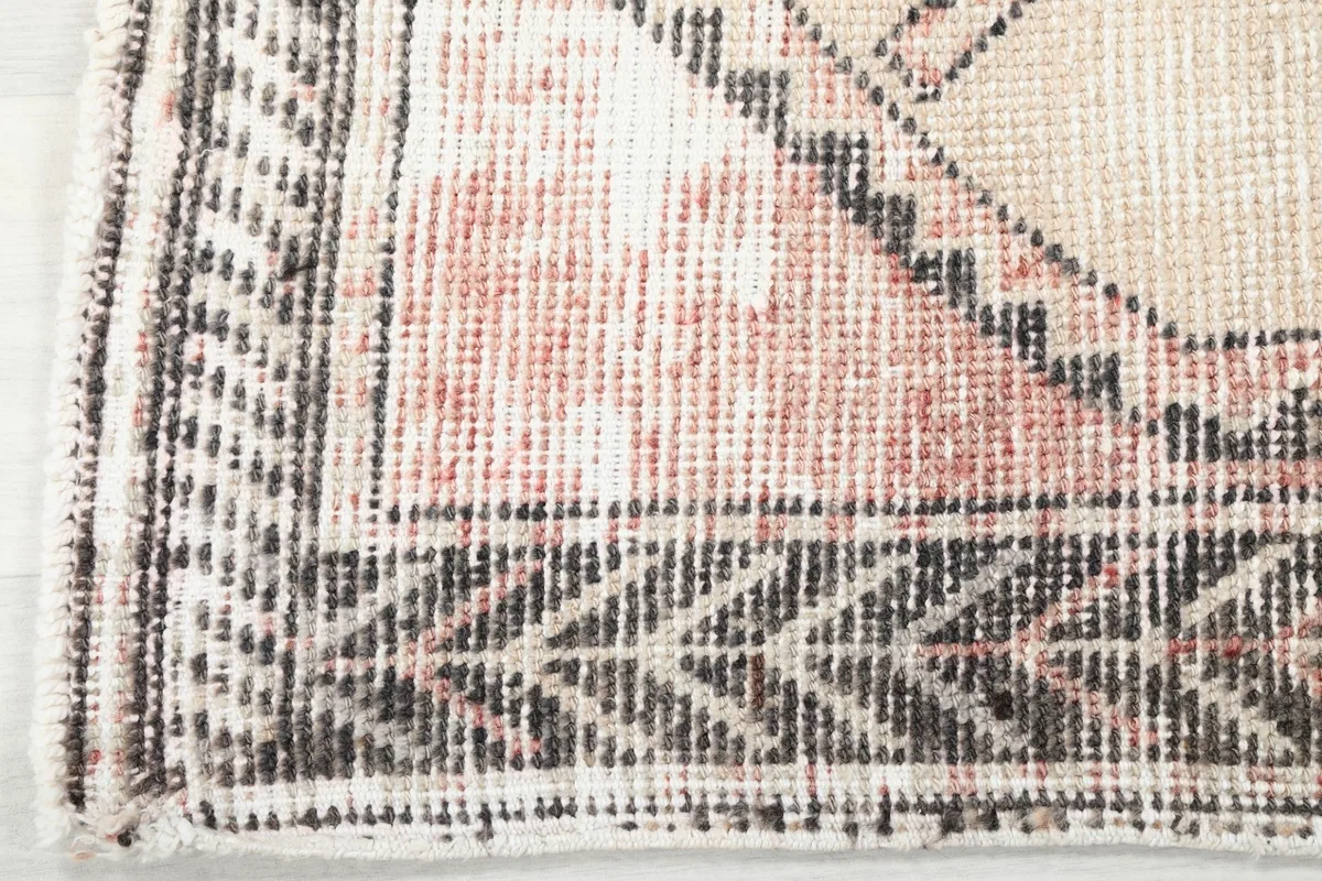 Detailed view of the rug's border pattern and corner