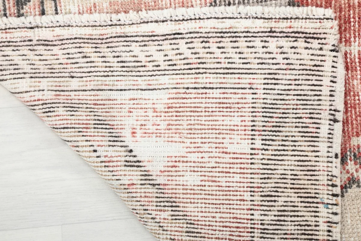 Close-up of the hand-knotted cotton foundation on the back of the rug