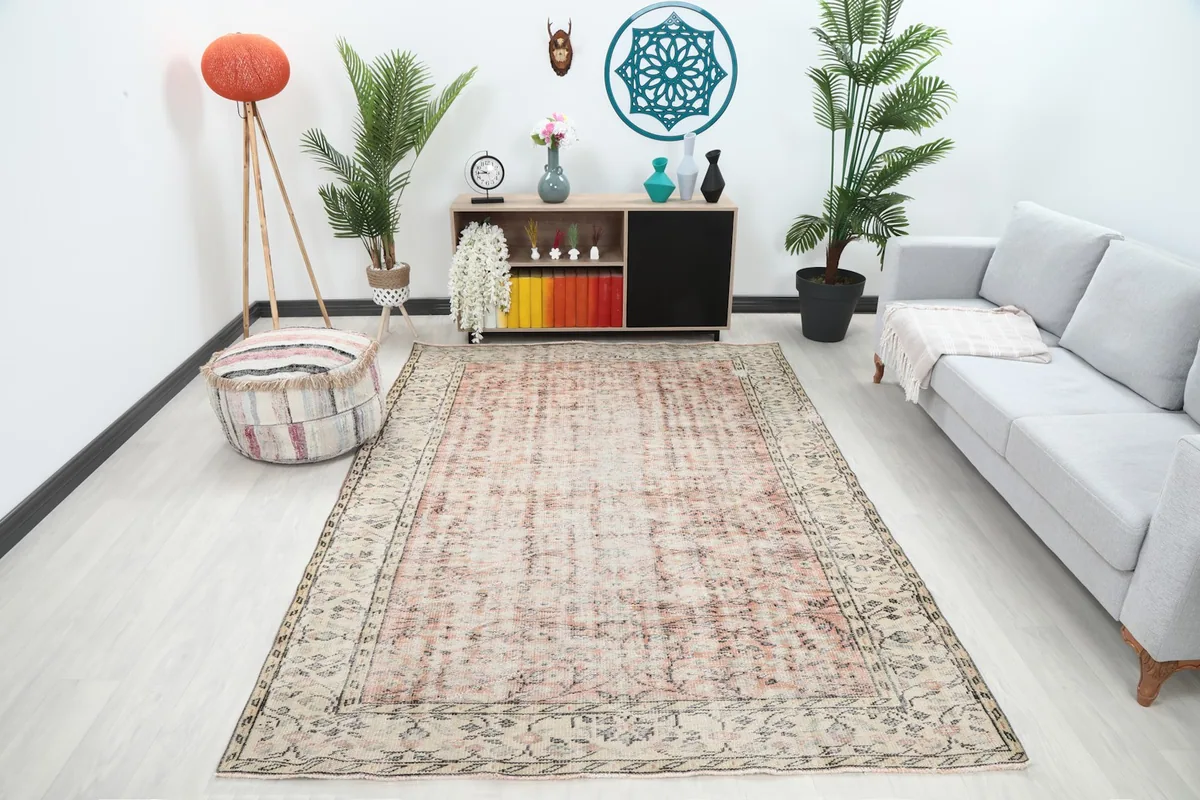 Rose Beige Floral Vintage rug displayed in a room setting with a sofa and decor