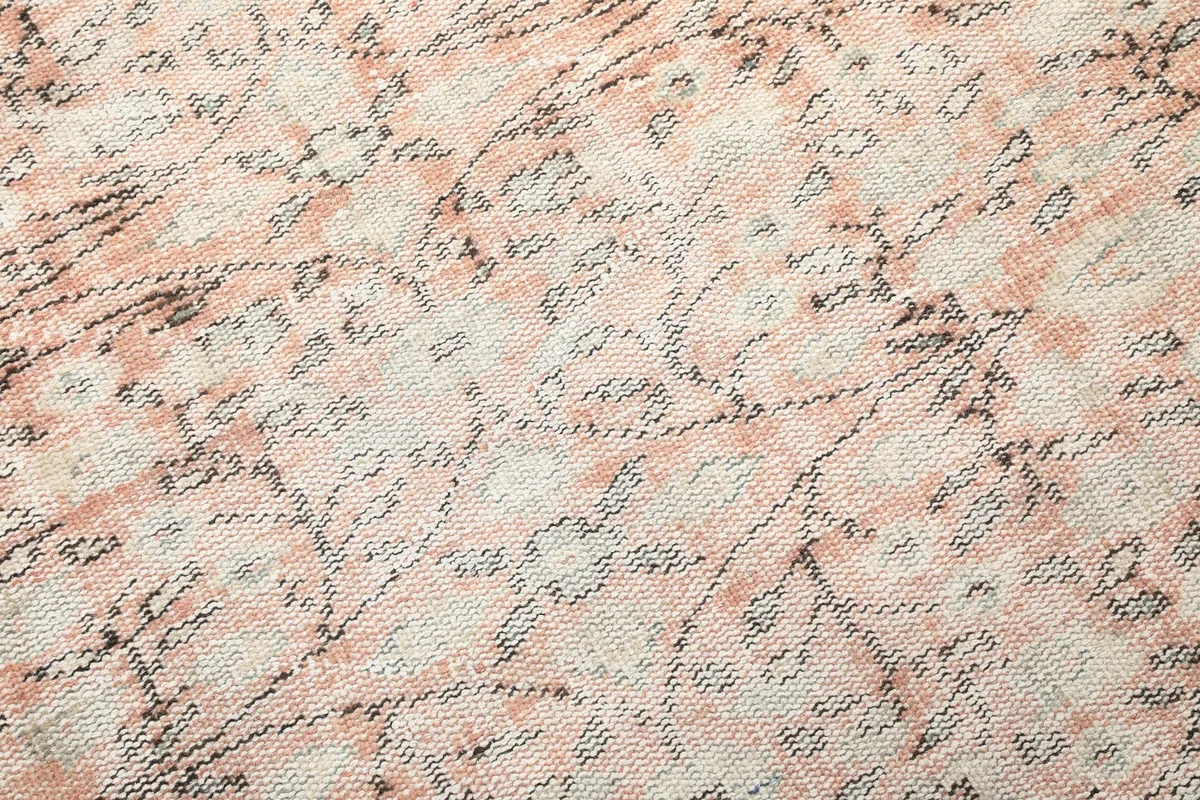 Close-up of the low wool pile and intricate knotting of the vintage rug