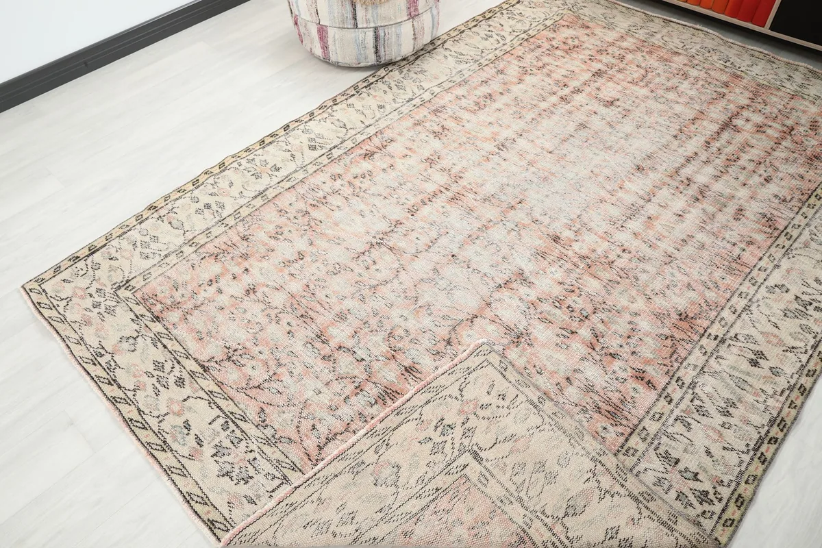 Angled view of the rug with a corner folded back, revealing the underside