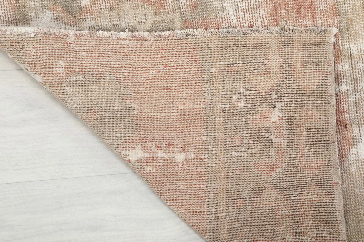 Underside view of the hand-knotted cotton foundation, showing the rug's construction.