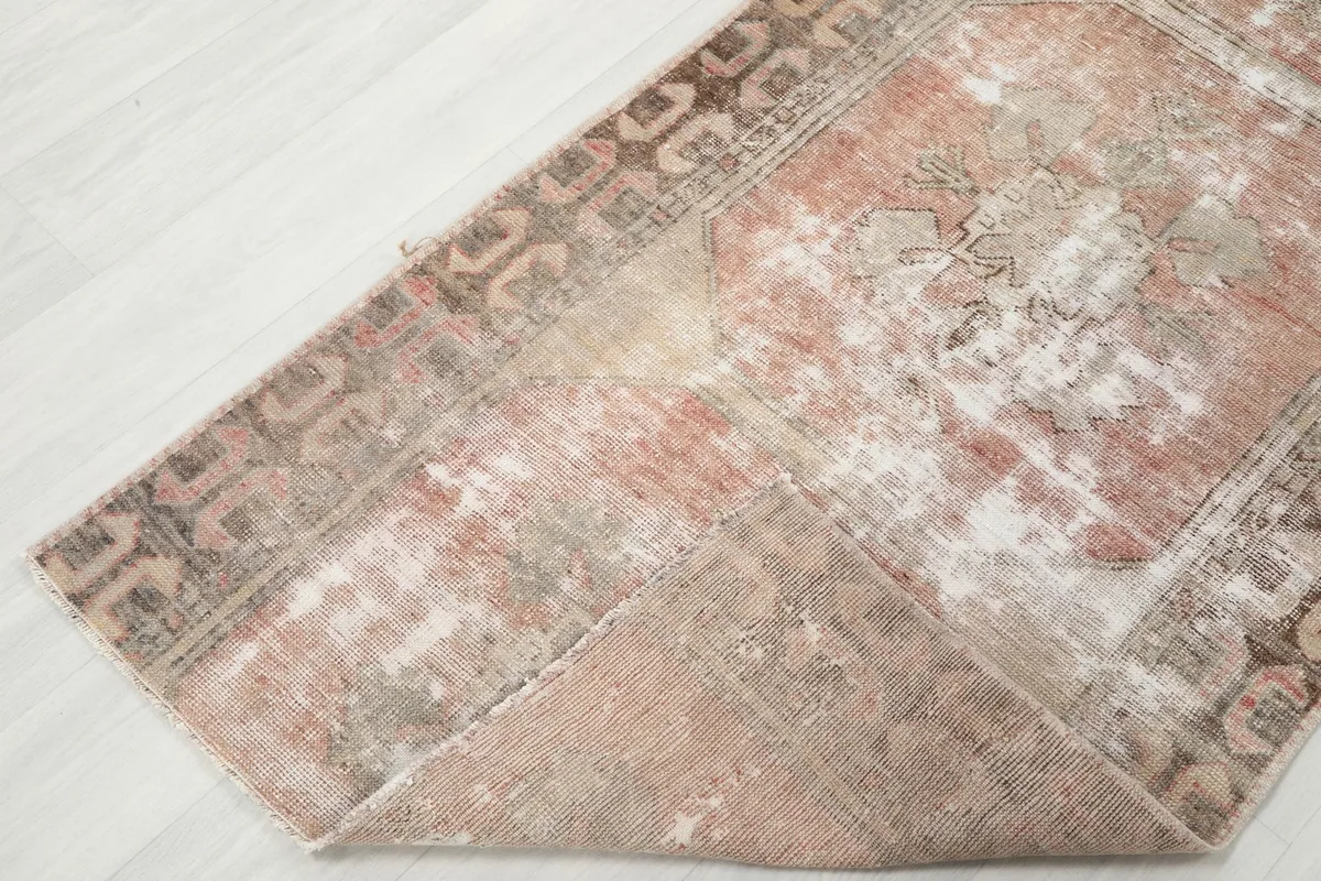 View of the runner folded to show its flexibility and the reverse side of the hand-knotted construction.