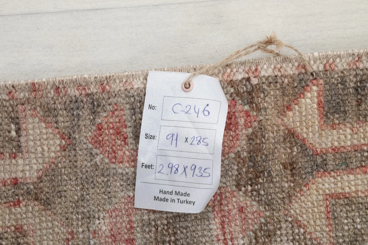 Tag showing the rug's dimensions in centimeters and feet, confirming its origin from Turkey.