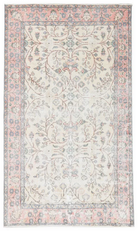 Full overhead view of the ivory and rose botanical vintage Anatolian rug on a white background.