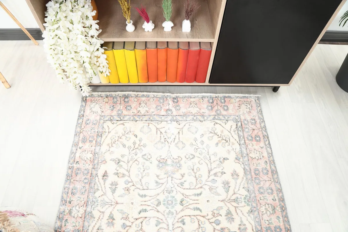 Overhead perspective of the rug in the room, focusing on the central design and colors.
