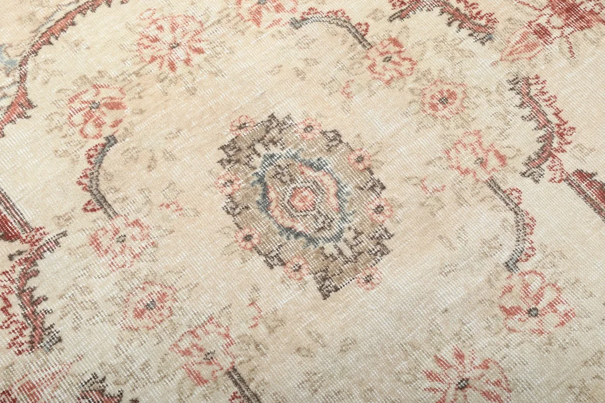 Close-up of the rug's central motif, showing the intricate hand-knotted wool pile and colors