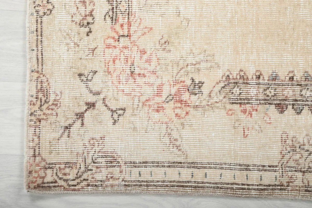 Corner detail of the rug, illustrating the border design and the texture of the low wool pile