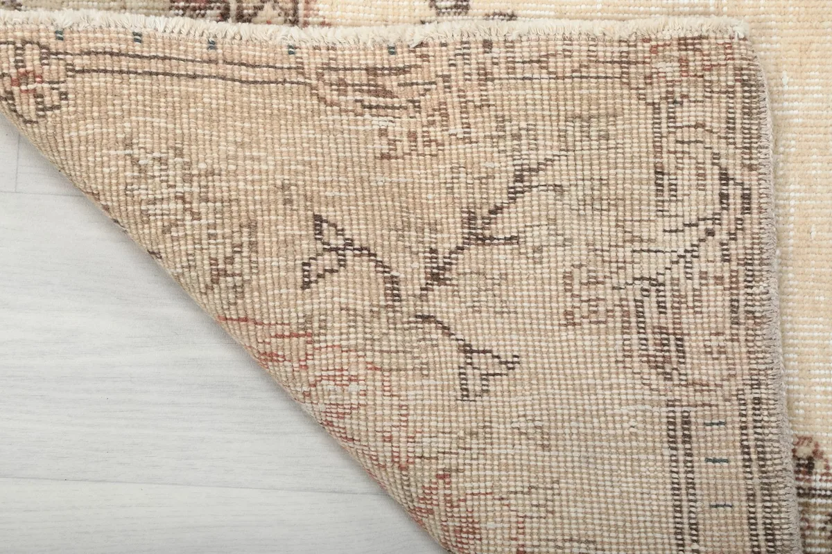 Close-up of the rug's reverse side, revealing the cotton foundation and fine knotting