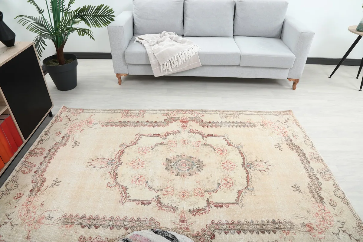 Overhead view of the ivory vintage rug in a room, highlighting its central medallion design