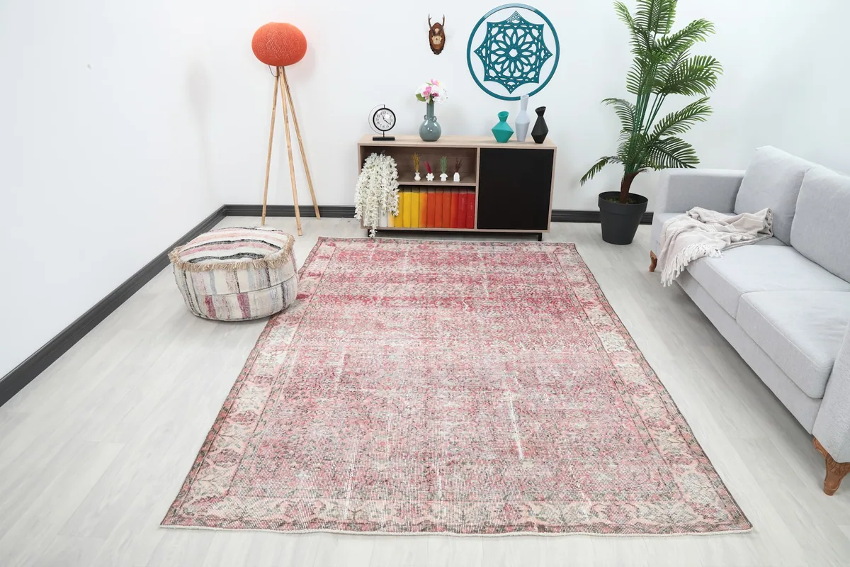 Vintage rose and cream Anatolian rug displayed in a modern living room setting
