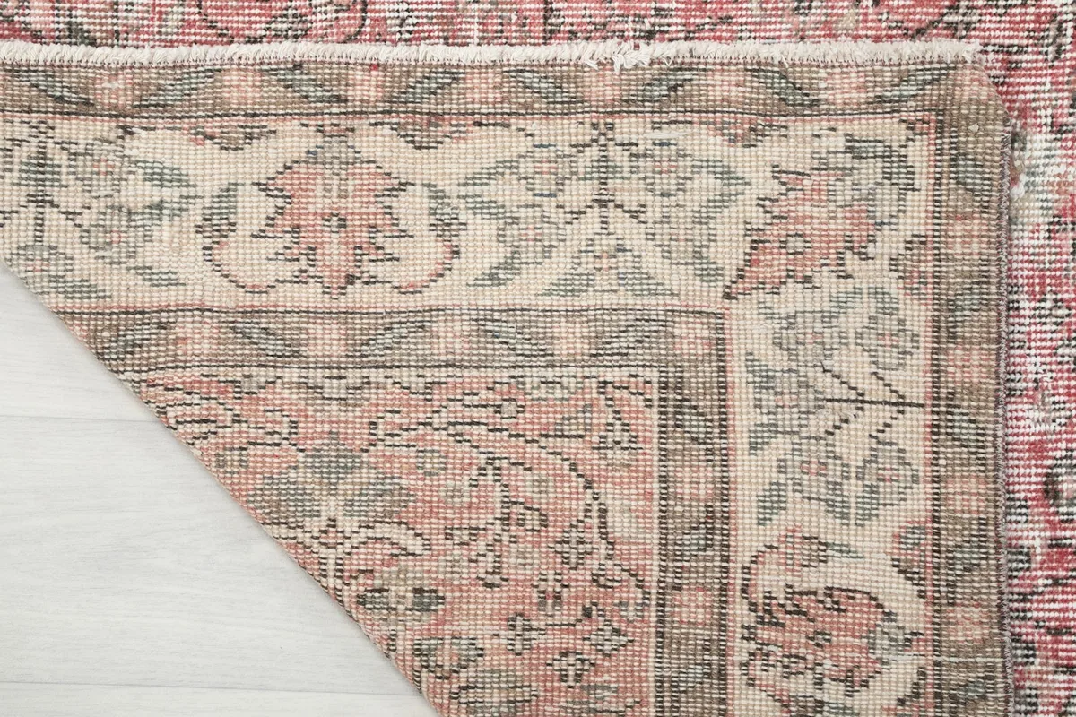 Close-up of the rug's reverse side, revealing the hand-knotted cotton foundation