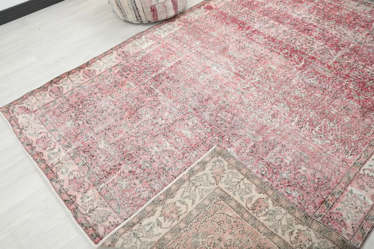 Corner of the rug folded back to show the reverse side and construction