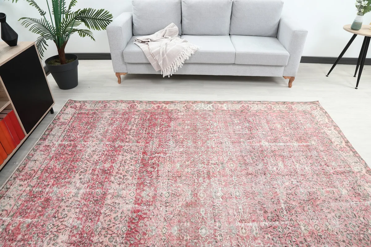 Overhead view of the rose vintage rug in a room, highlighting its full size