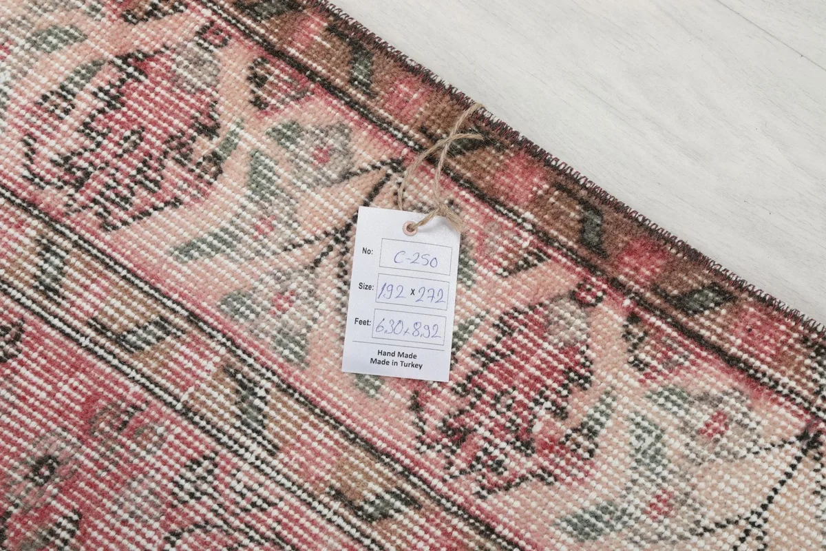 Tag on the back of the rug, indicating it is hand made in Turkey