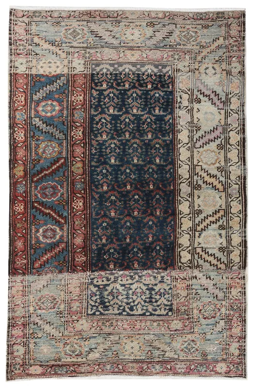Full top view of the navy, blue, rust, and beige patchwork vintage Anatolian rug