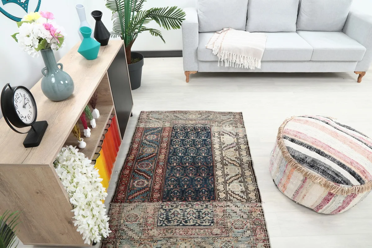 High angle shot of the rug in the room, highlighting its navy and rust tones