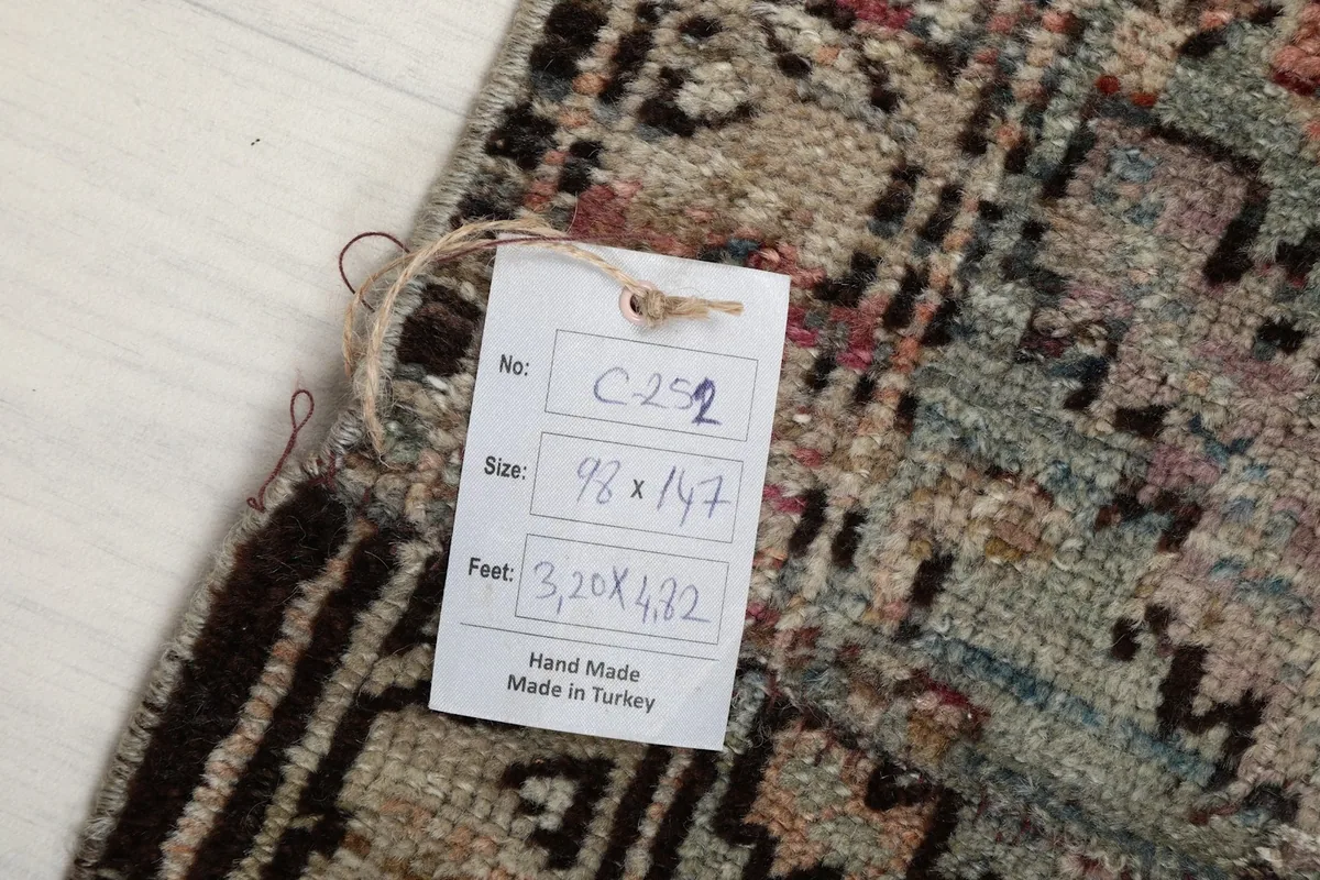 Rug tag displaying the item number, size in centimeters and feet, and origin