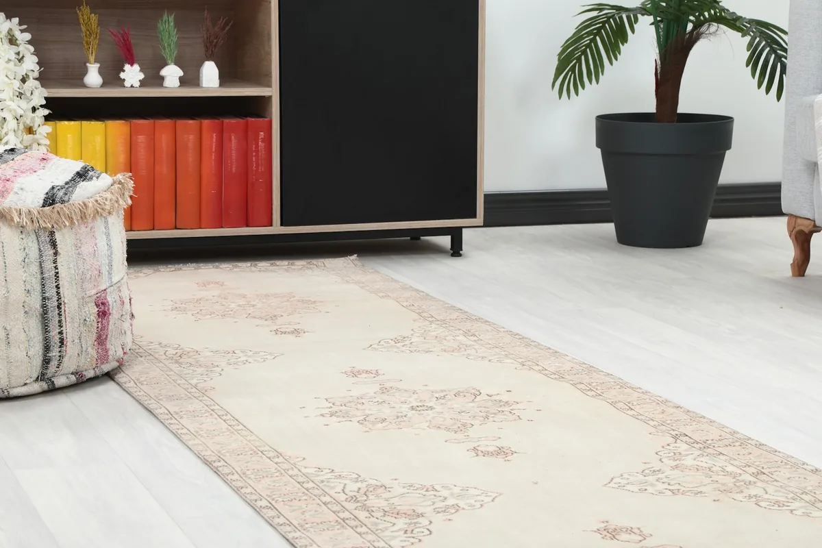 Close-up view of the runner rug in a room, showing detail near furniture