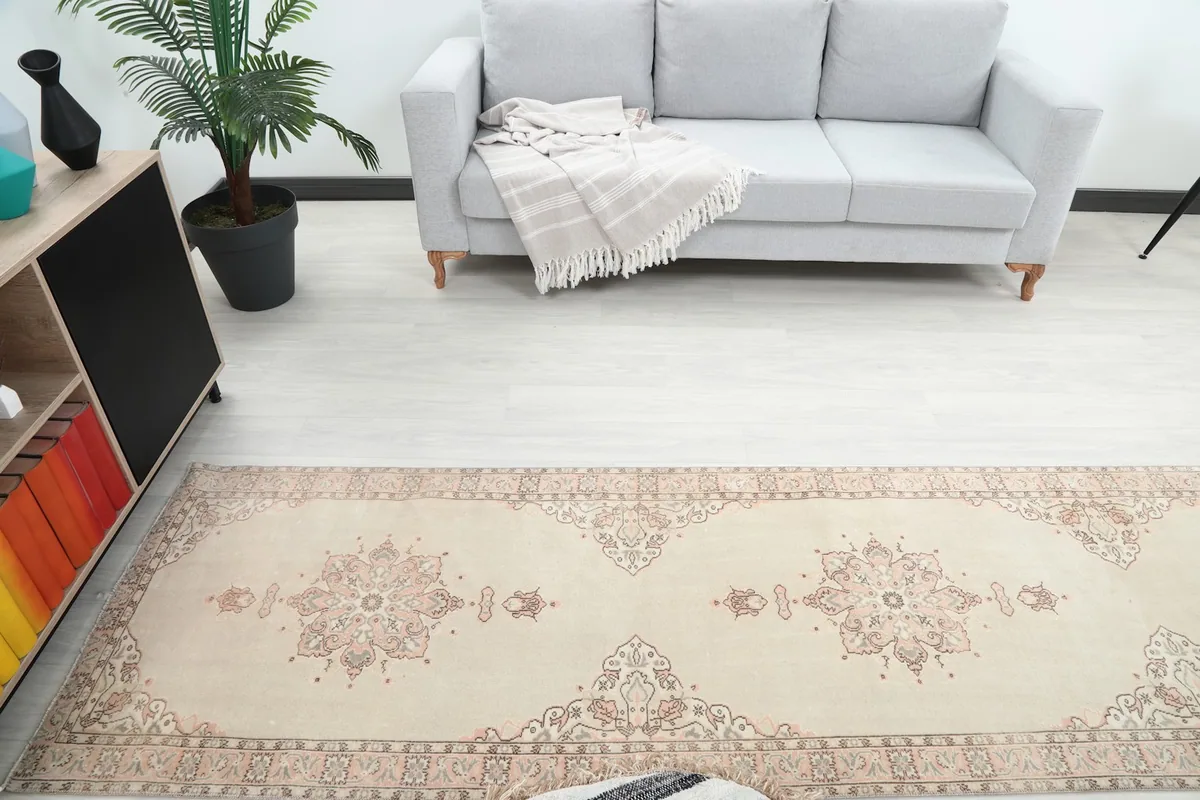 Overhead view of the runner rug in a room, highlighting its position relative to a sofa