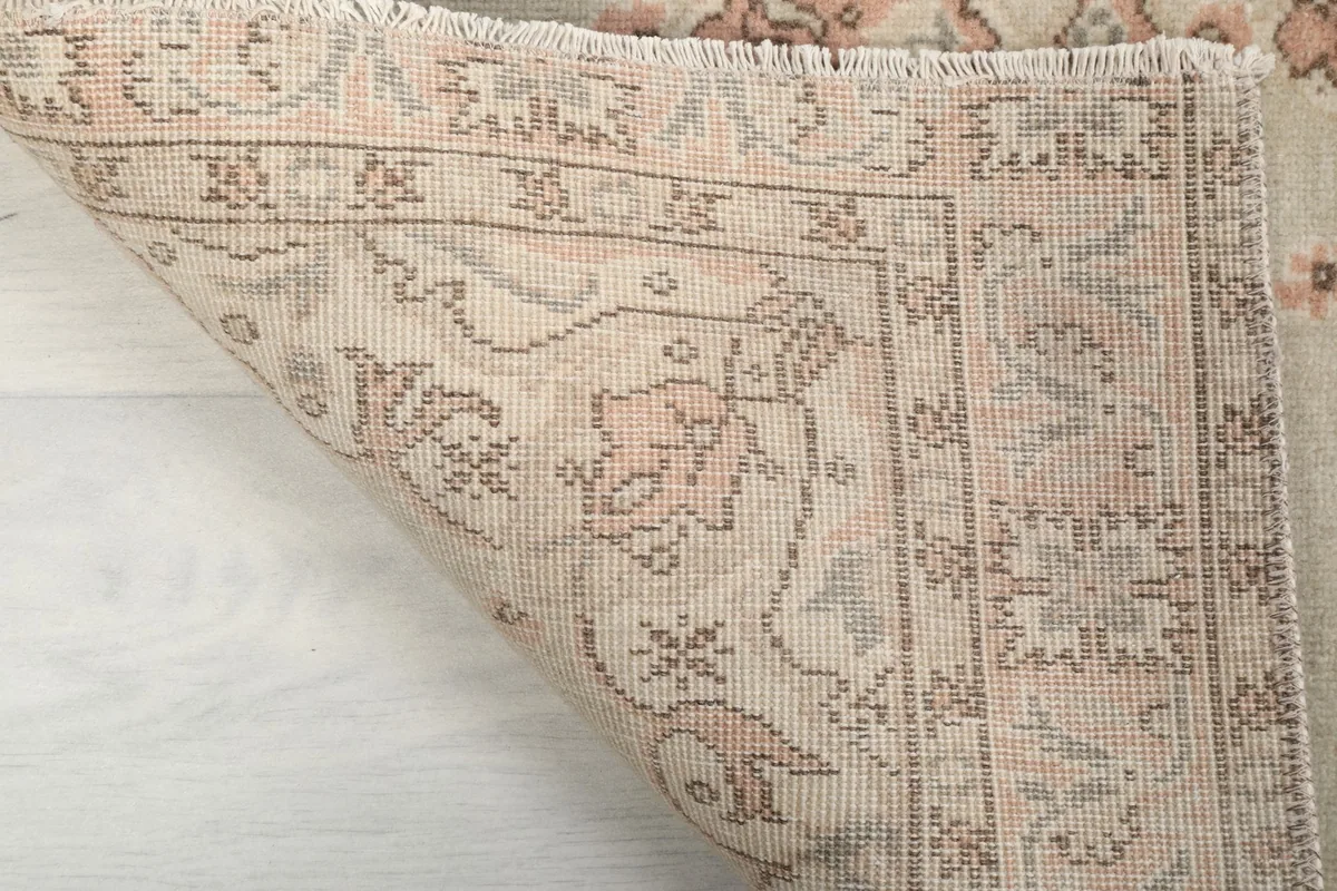 Close-up of the rug's back, revealing the hand-knotted wool pile and cotton foundation