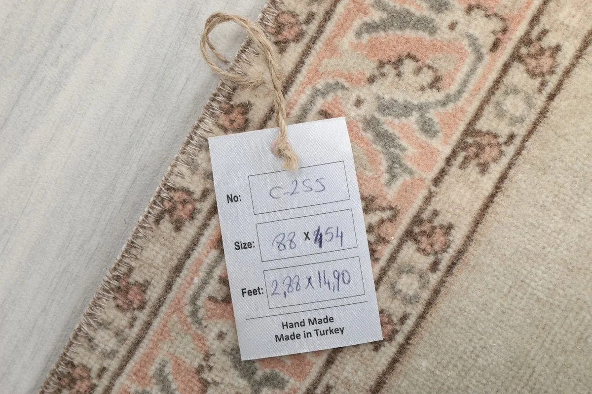 Tag on the rug showing measurements and origin, confirming it is handmade in Turkey