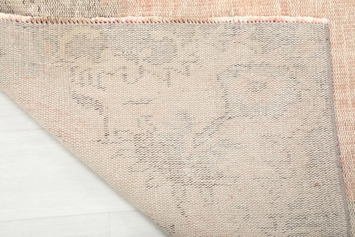 Underside view of the rug showing the hand-knotted cotton foundation and weave