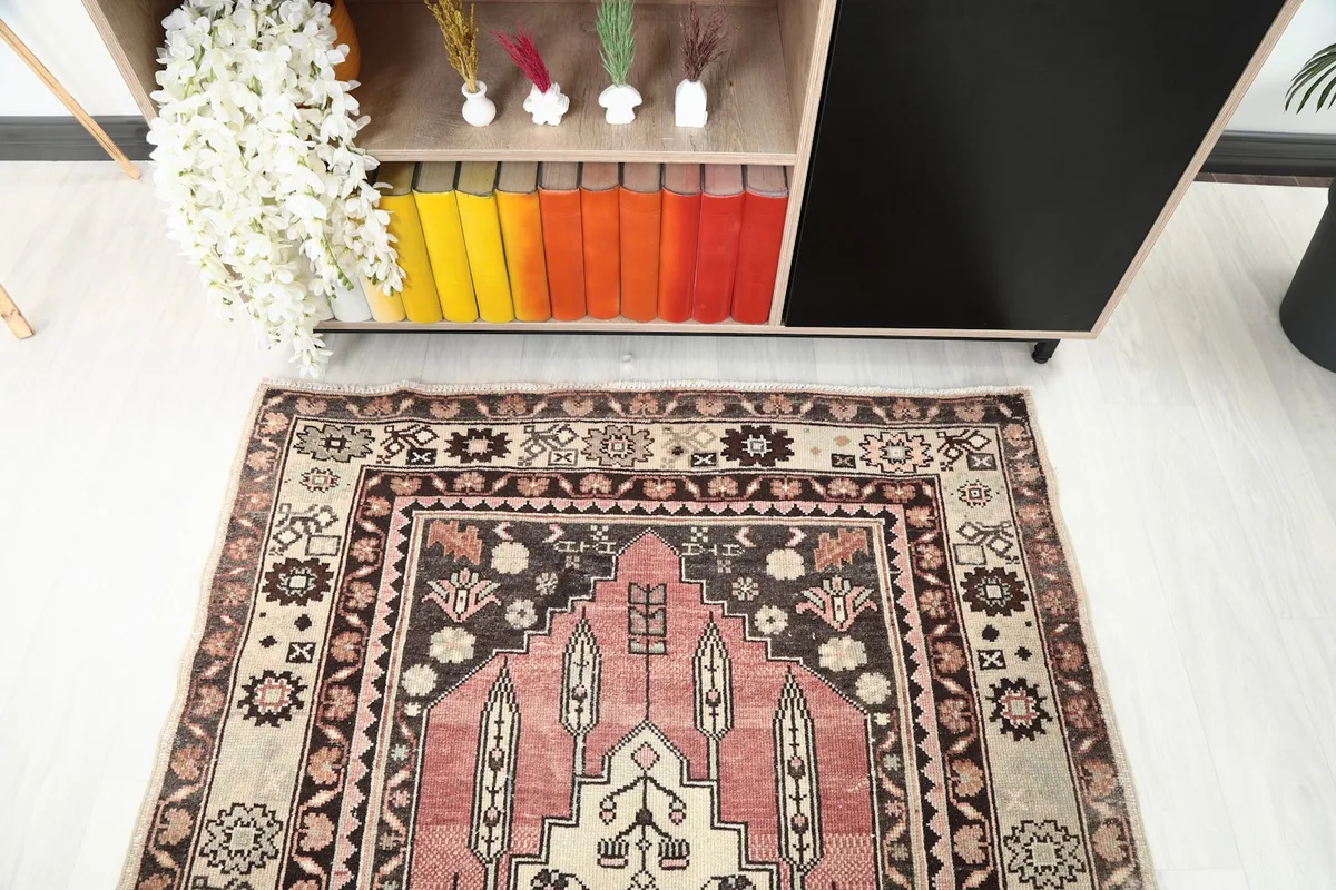 Detailed view of the top part of the rug in a room setting, showing patterns