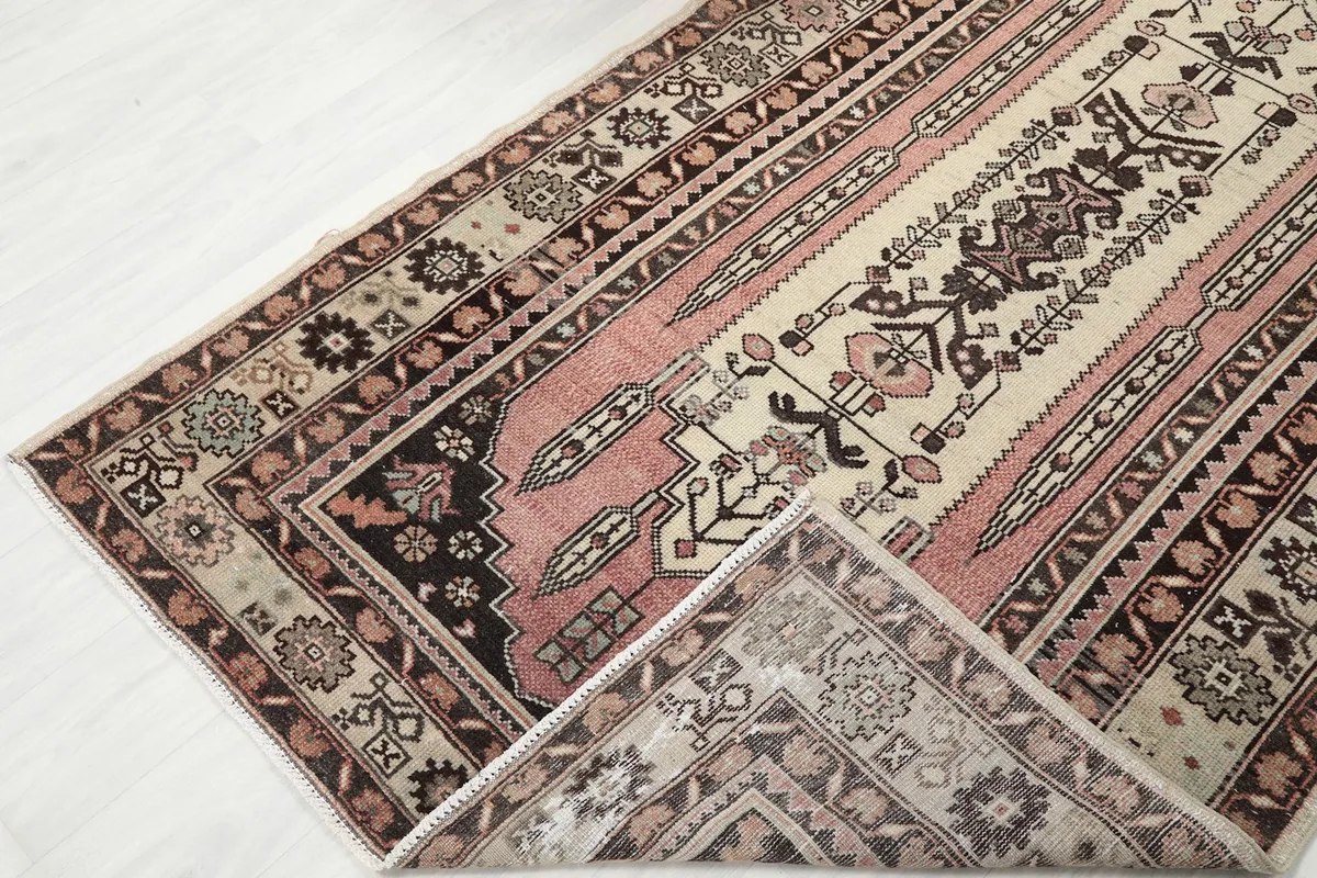 View of the rug's back and front, showing the cotton foundation and wool pile