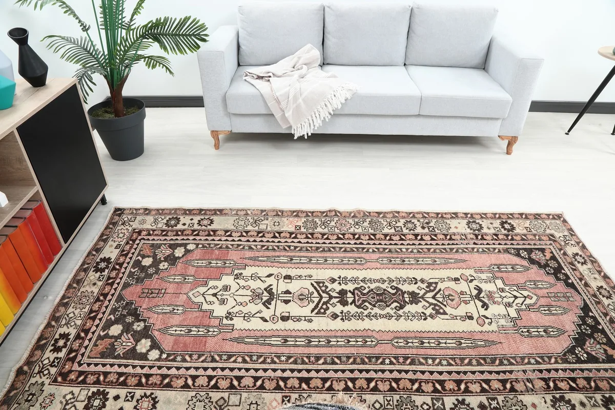 Overhead view of the rose and beige rug in a room, highlighting its placement