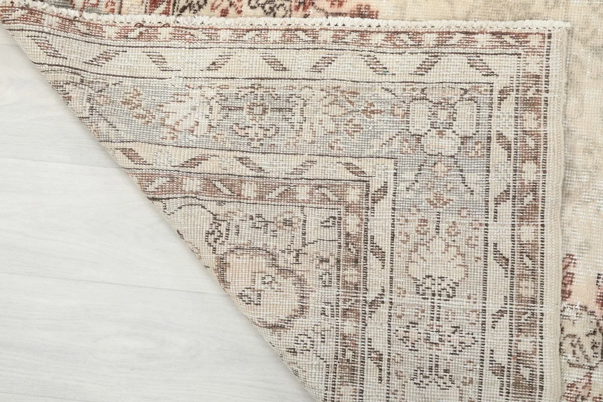 Detailed view of the rug's reverse side, revealing the hand-knotted wool on cotton foundation