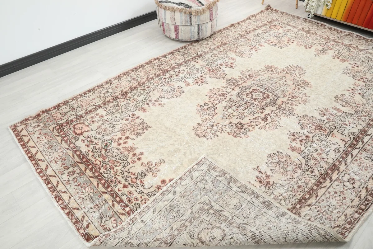 View of the rug folded back to show the cotton foundation and hand-knotted construction