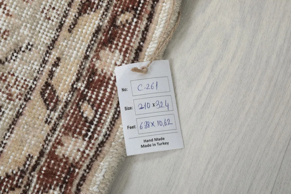 Tag showing the rug's dimensions in feet and centimeters, confirming origin and material