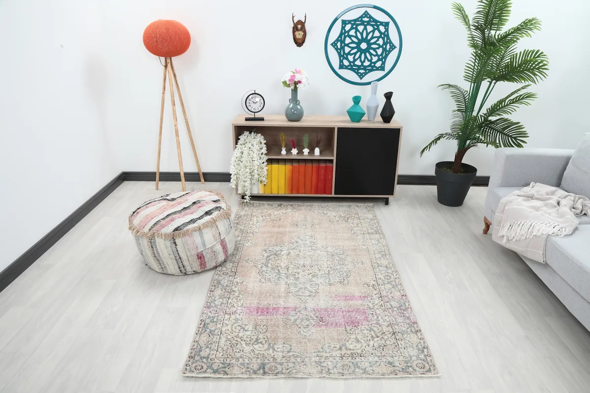 Vintage Anatolian rug displayed in a bright living room setting with a light gray sofa