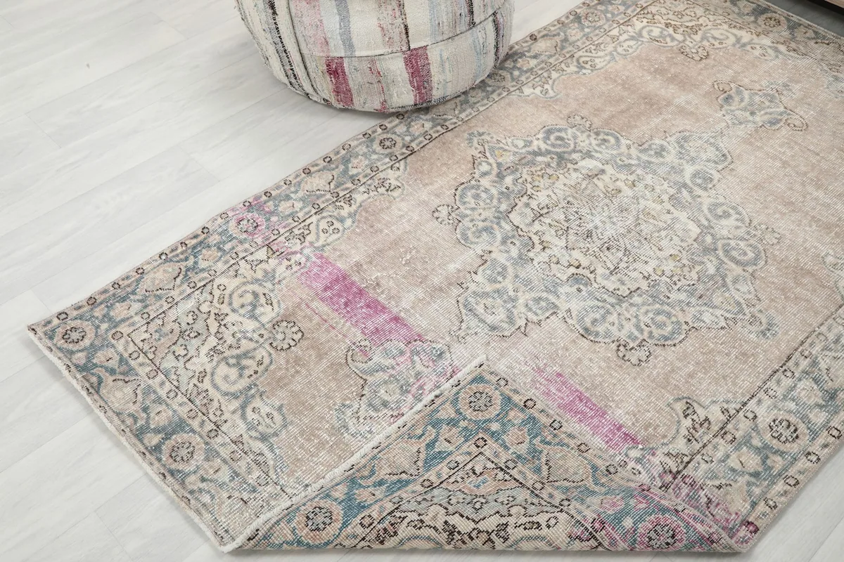 Corner of the rug folded back, revealing the reverse side and construction