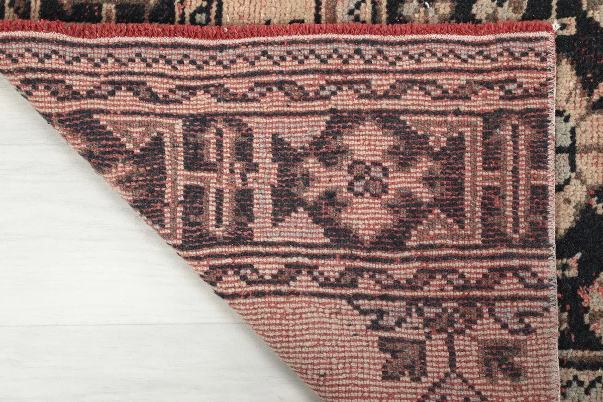 Detailed view of the back of the rug, revealing the tight hand-knotted wool pile on cotton foundation.
