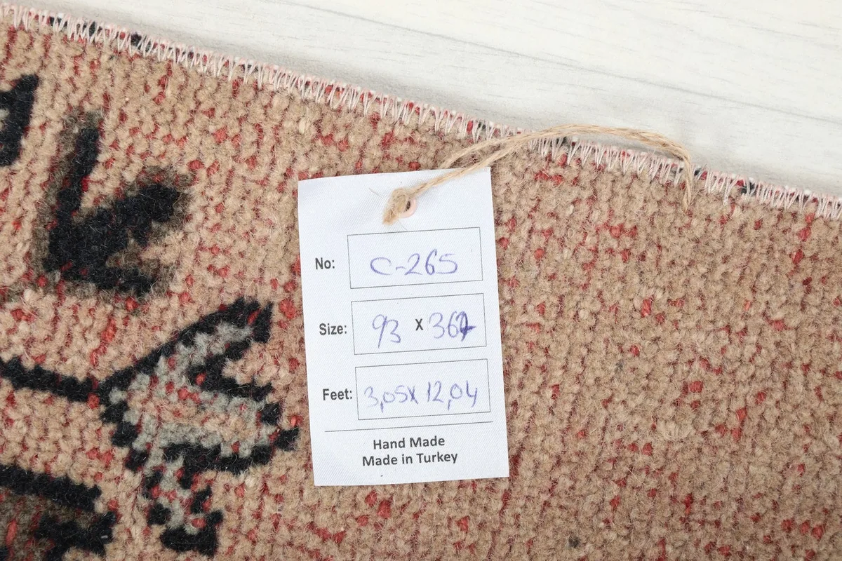 Close-up of the product tag attached to the back of the rug, showing size and origin details.