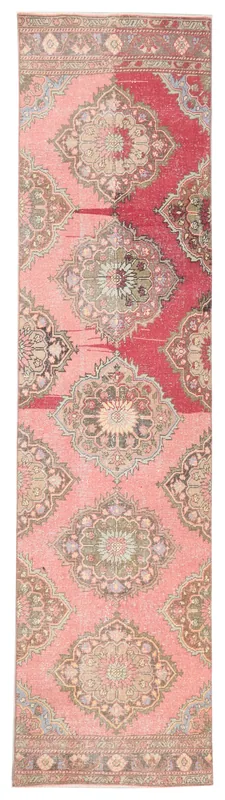 Full overhead view of the vintage pink and red Anatolian runner rug with medallion motifs