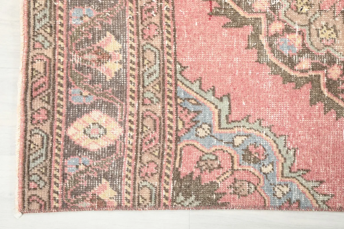 Close-up of the rug's border and a section of the main field with geometric patterns