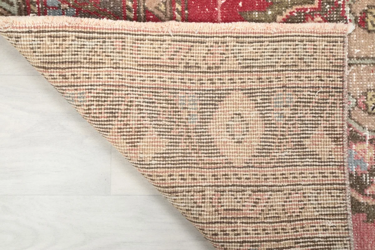 Underside of the Anatolian runner rug, showing the cotton foundation and hand-knotted structure