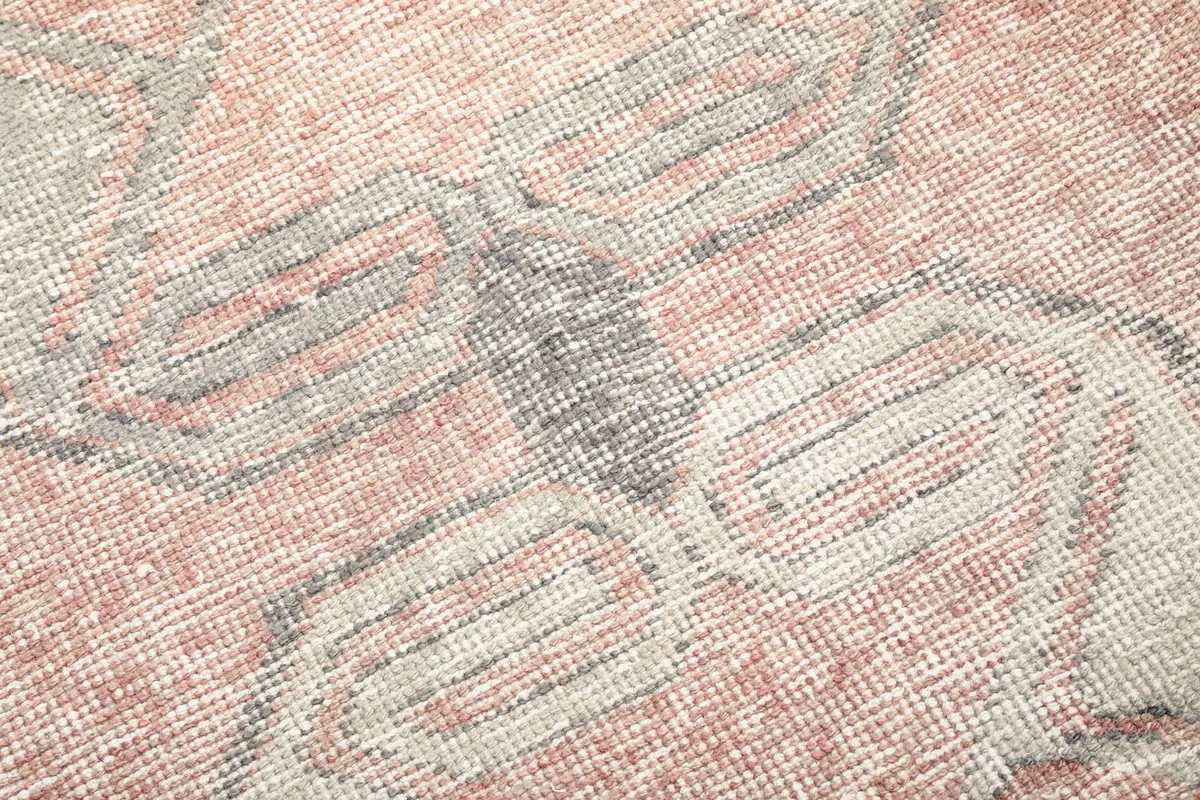 Close-up of the low wool pile and the intricate hand-knotted texture of the rug.