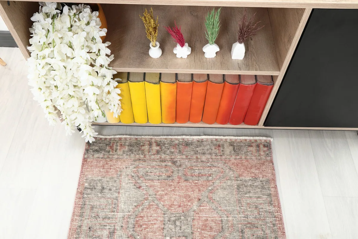 Overhead view of one end of the runner rug, showing the faded geometric design and colors.