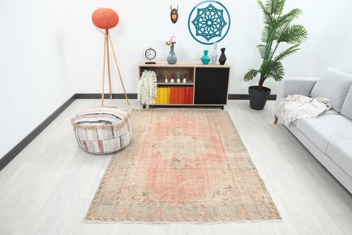 Vintage Anatolian rug in a living room setting with a light gray sofa and modern decor.