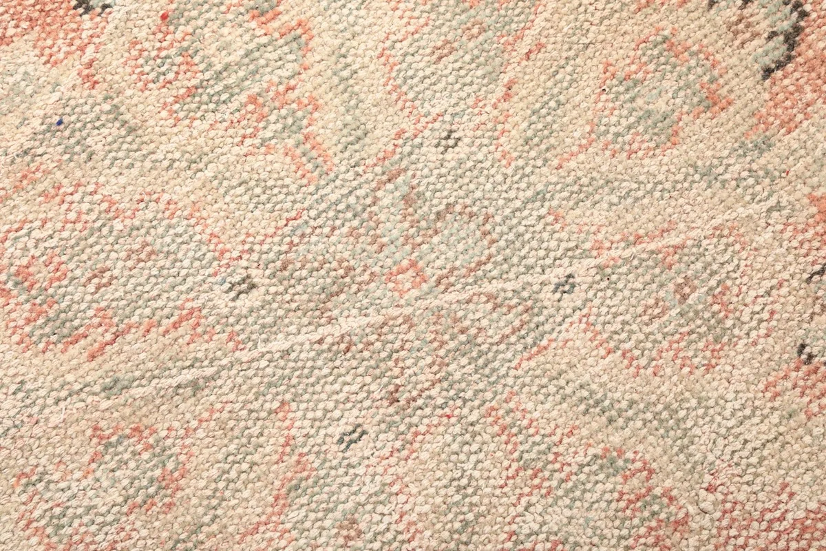 Close-up of the hand-knotted wool pile, showing its low profile and texture.
