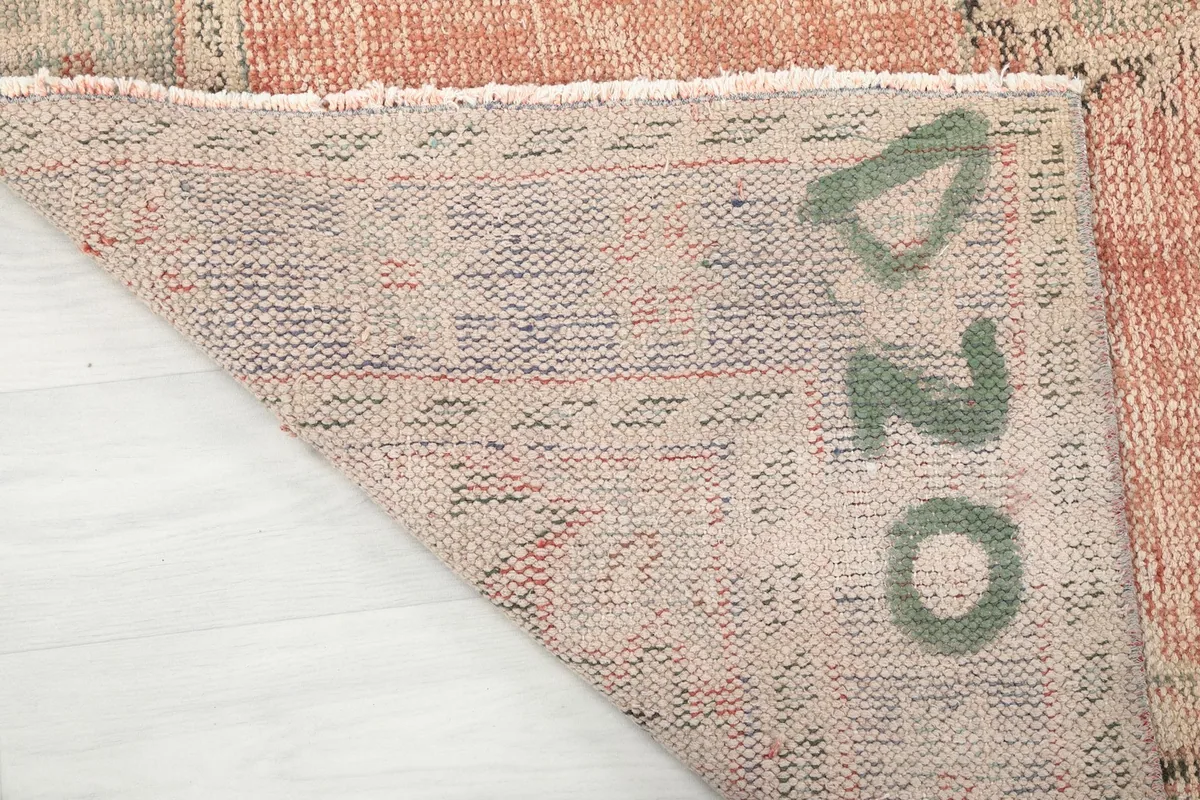 Close-up of the rug's back, displaying the tight hand-knotted construction and foundation.