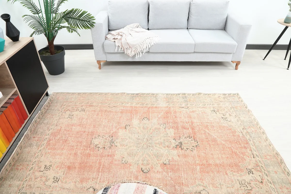 Overhead view of the rug in a room, highlighting the central medallion and surrounding patterns.