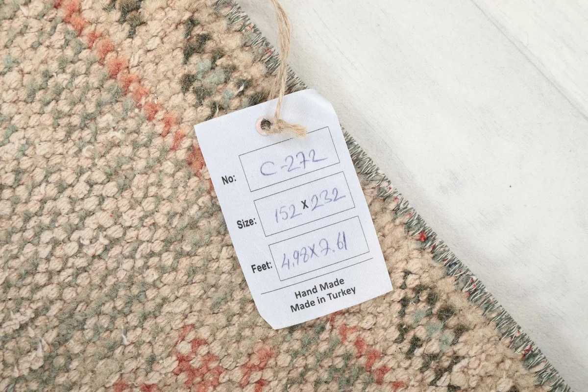 Product tag showing the rug's dimensions in centimeters and feet, confirming it is handmade in Turkey.