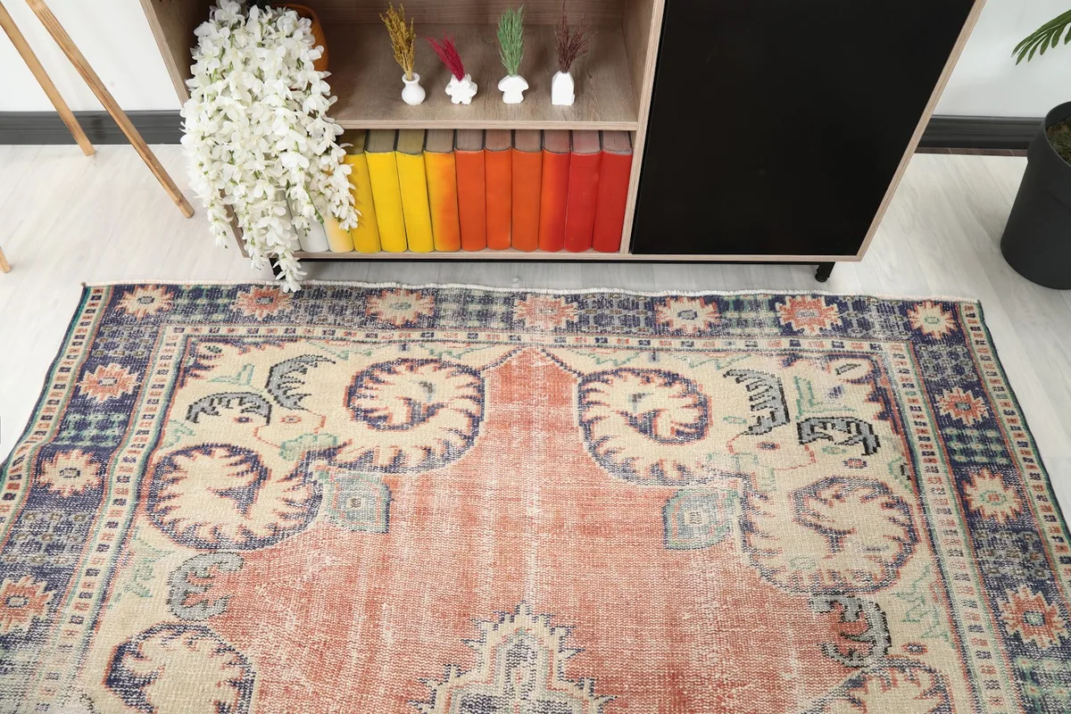 Detailed angle of the rug's upper section, highlighting the border and field motifs